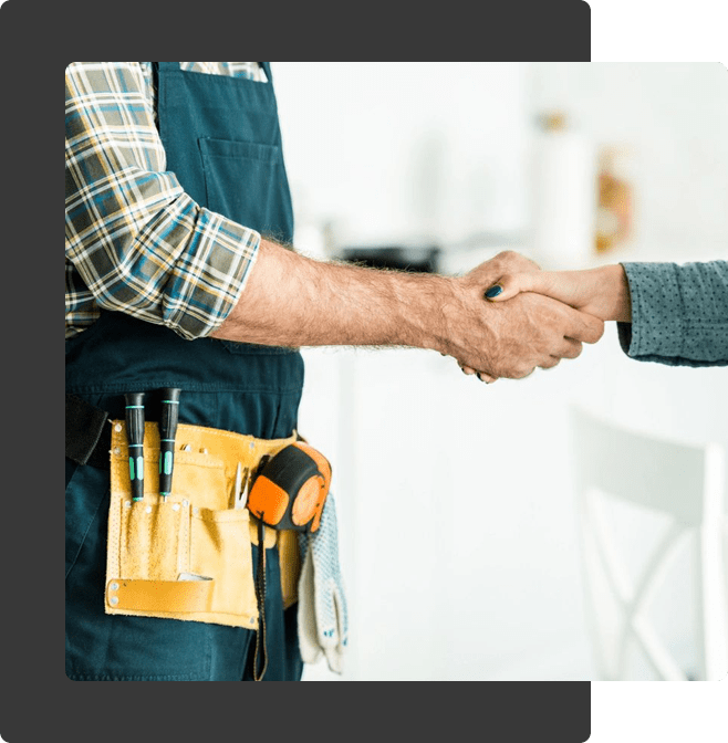 Plumber and Client Shaking Hands in Kitchen